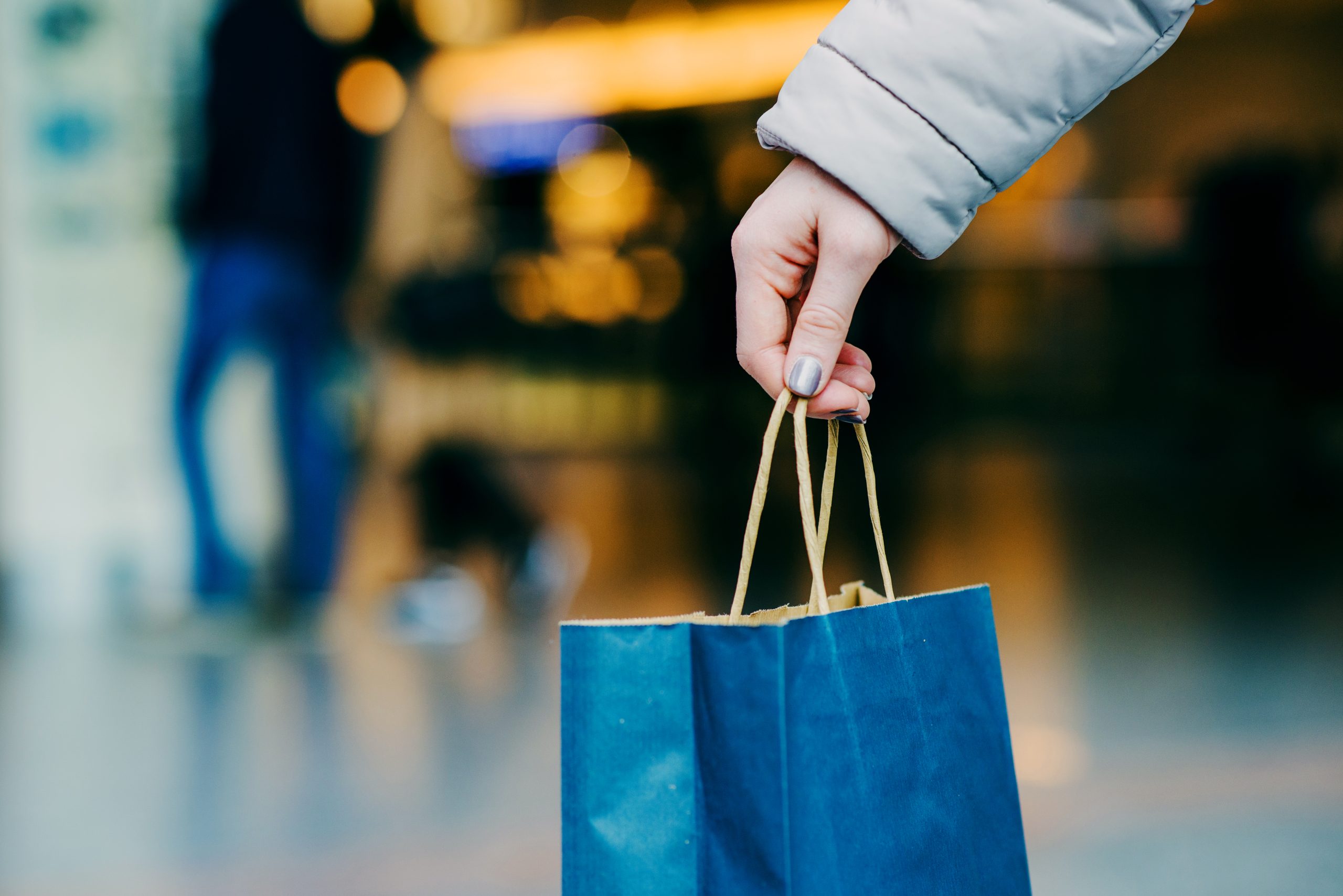 womans-hand-holding-shopping-bag